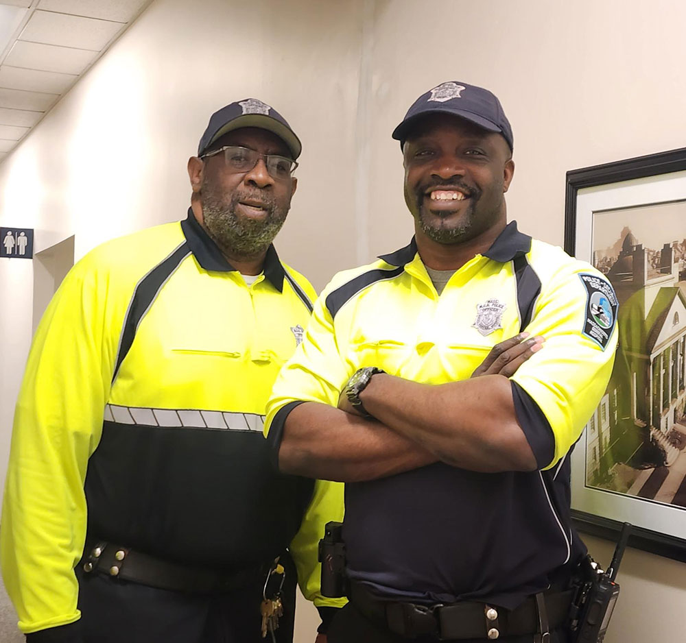 Larry Tree Washington and Harold Roy in their security uniforms at work.